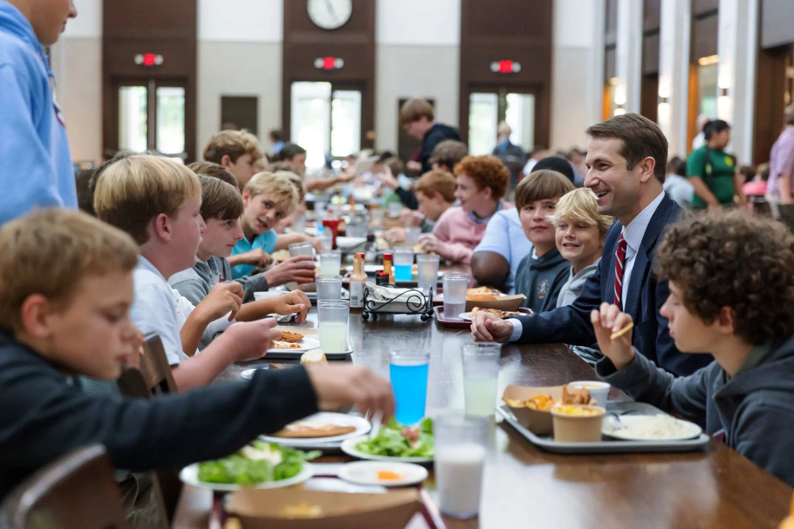 Students and teacher sat at lunch
