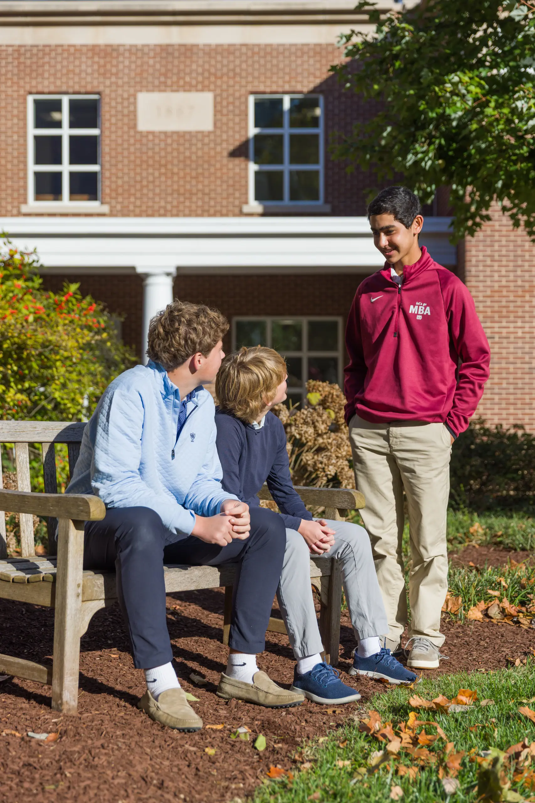 Three boys talking outside
