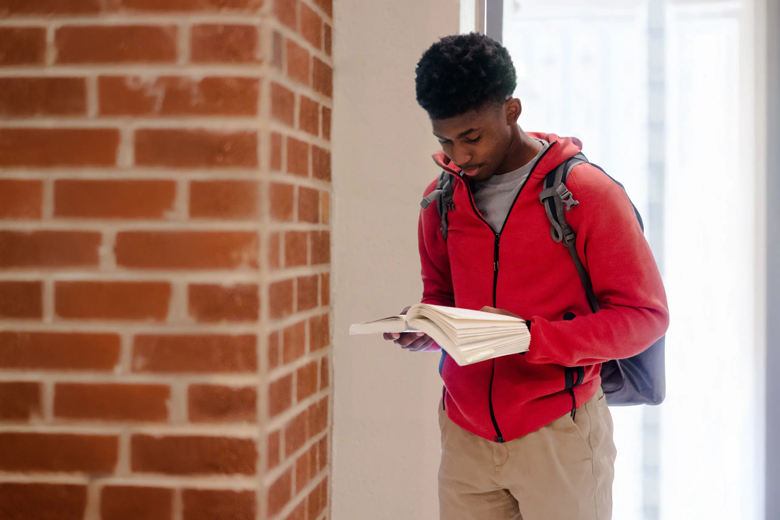 Student reading in hall