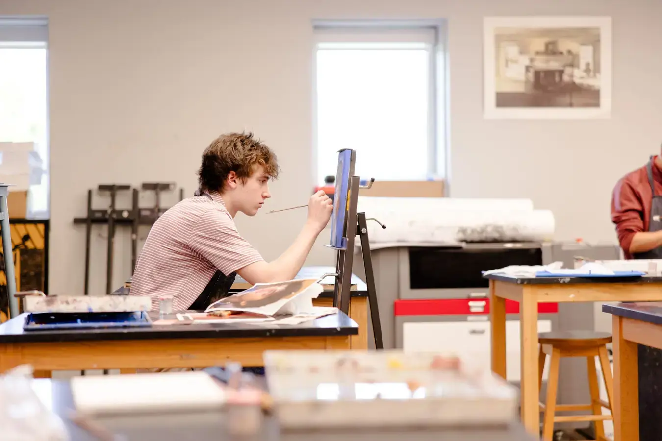 Student focused on art project