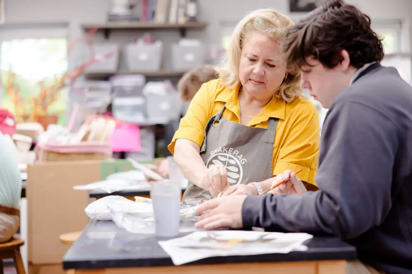 Art teacher with student