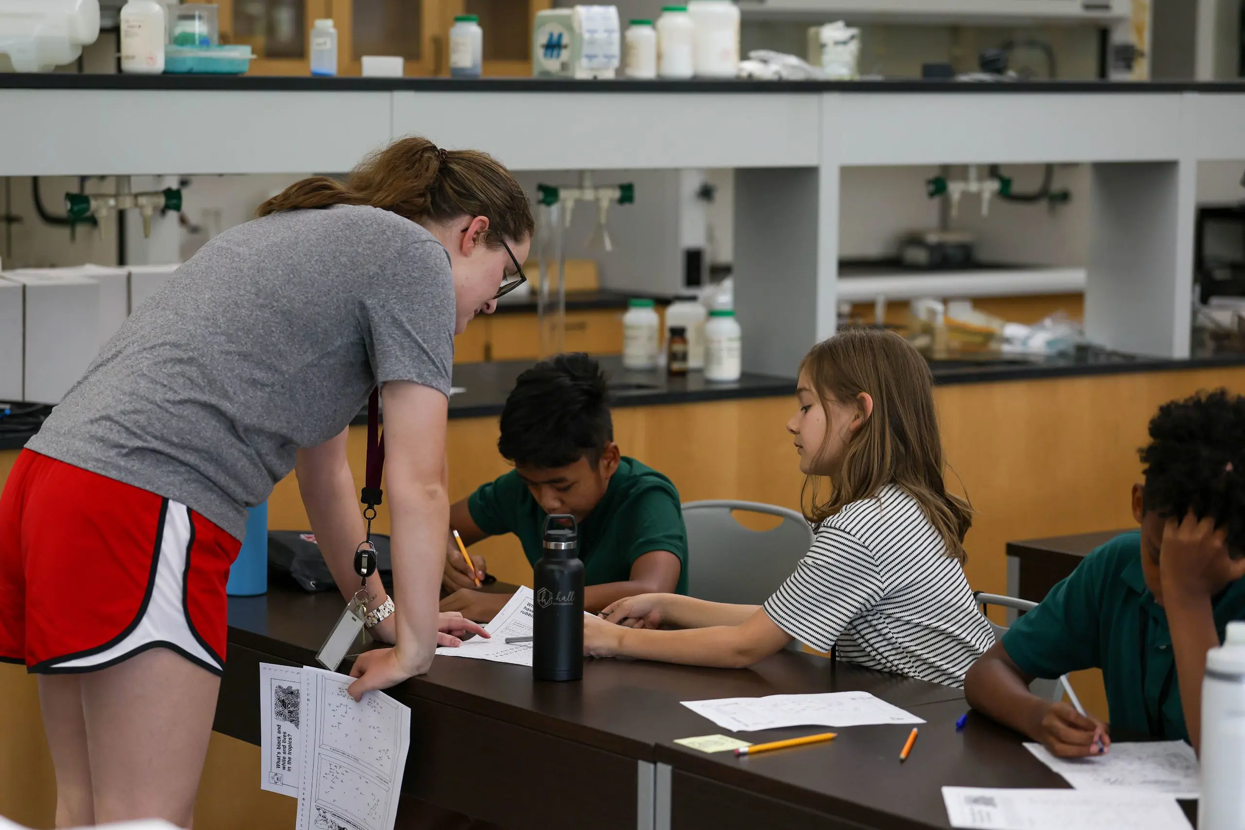 Teacher helping child at camp