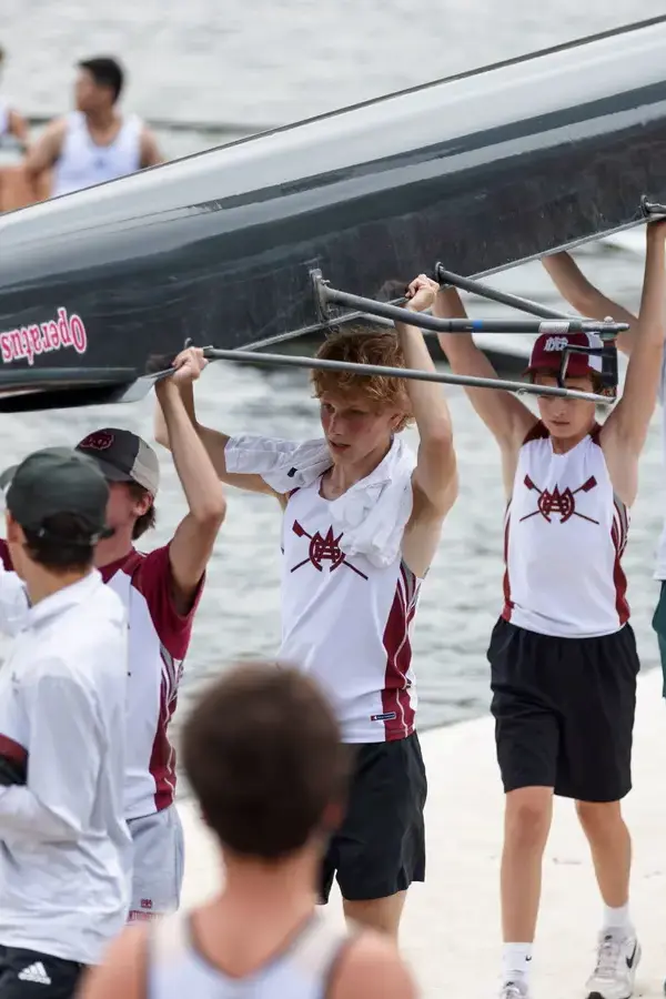 Rowing team carrying boat