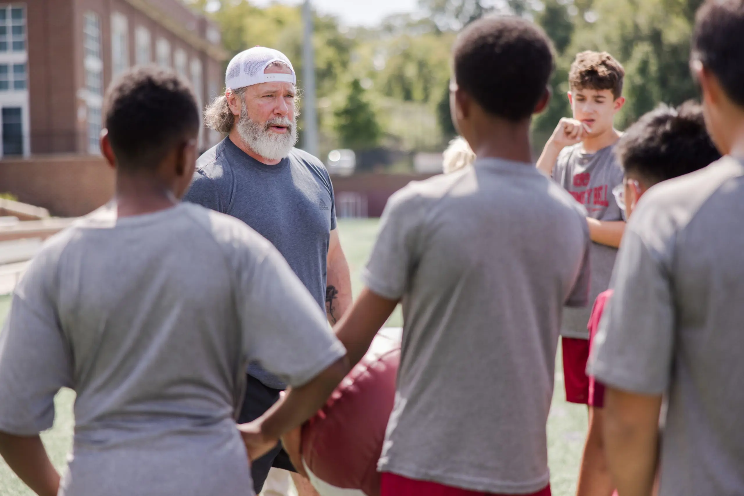 Sports coach with students
