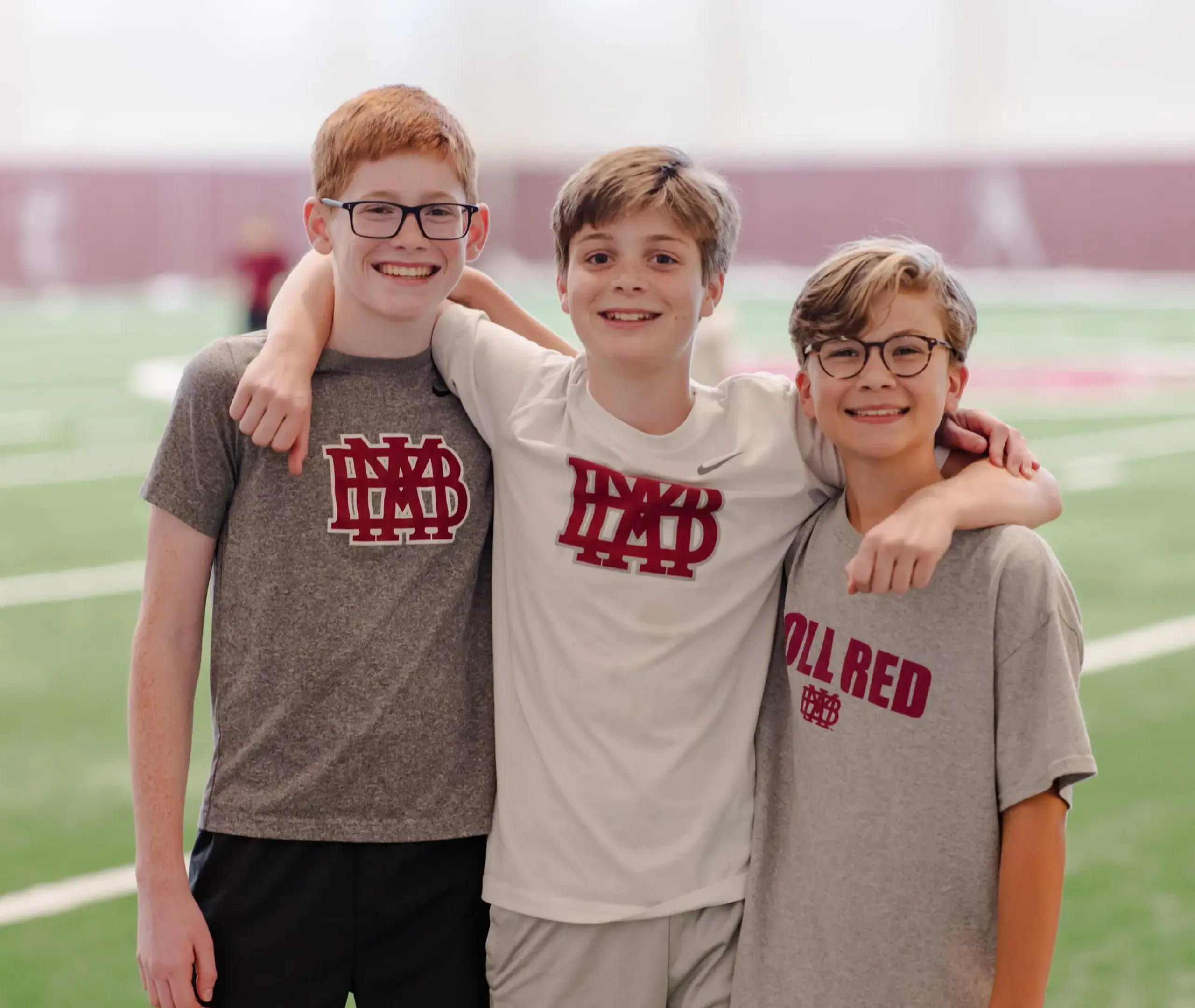 Three boys with arms around eachother