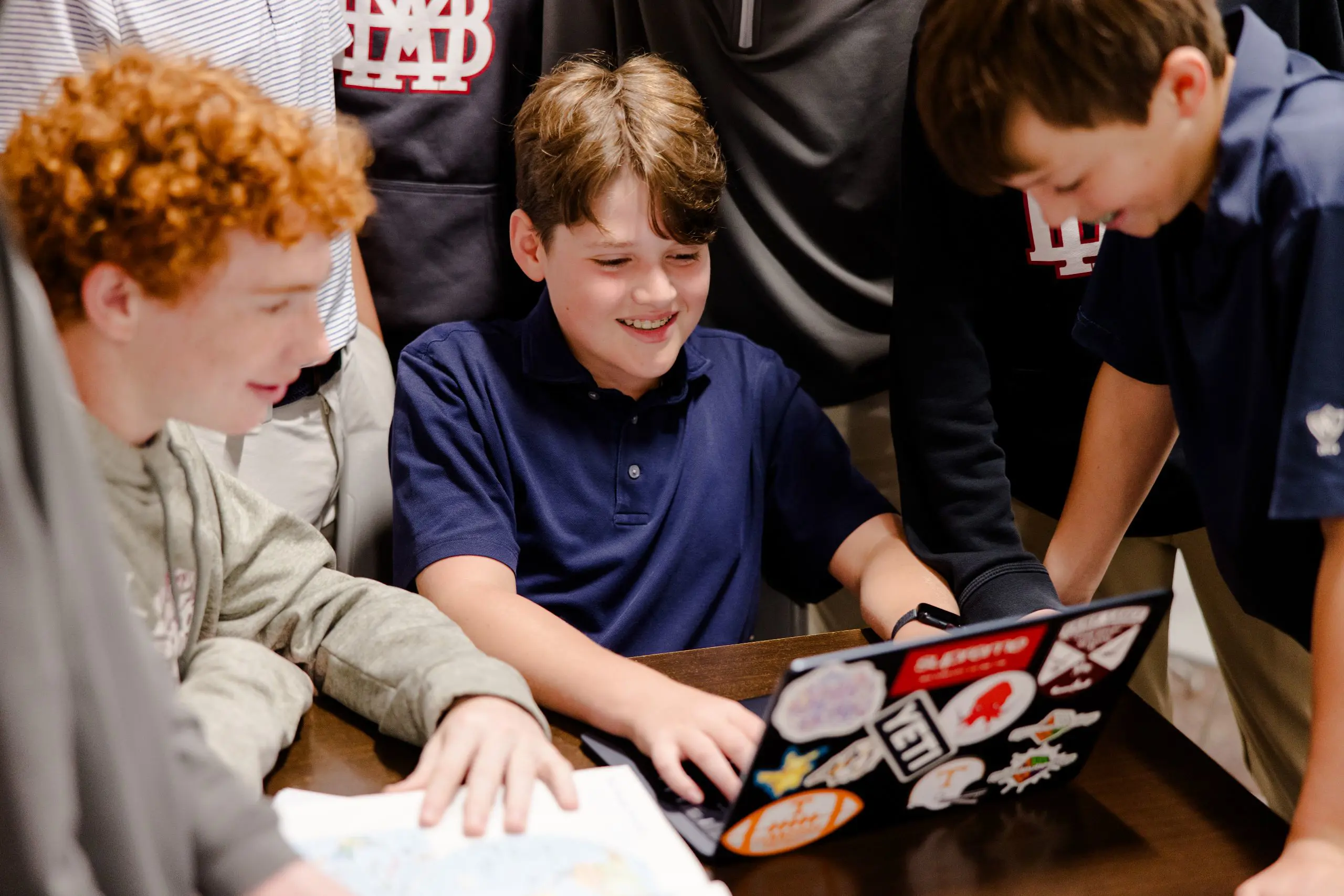 Boys around laptop