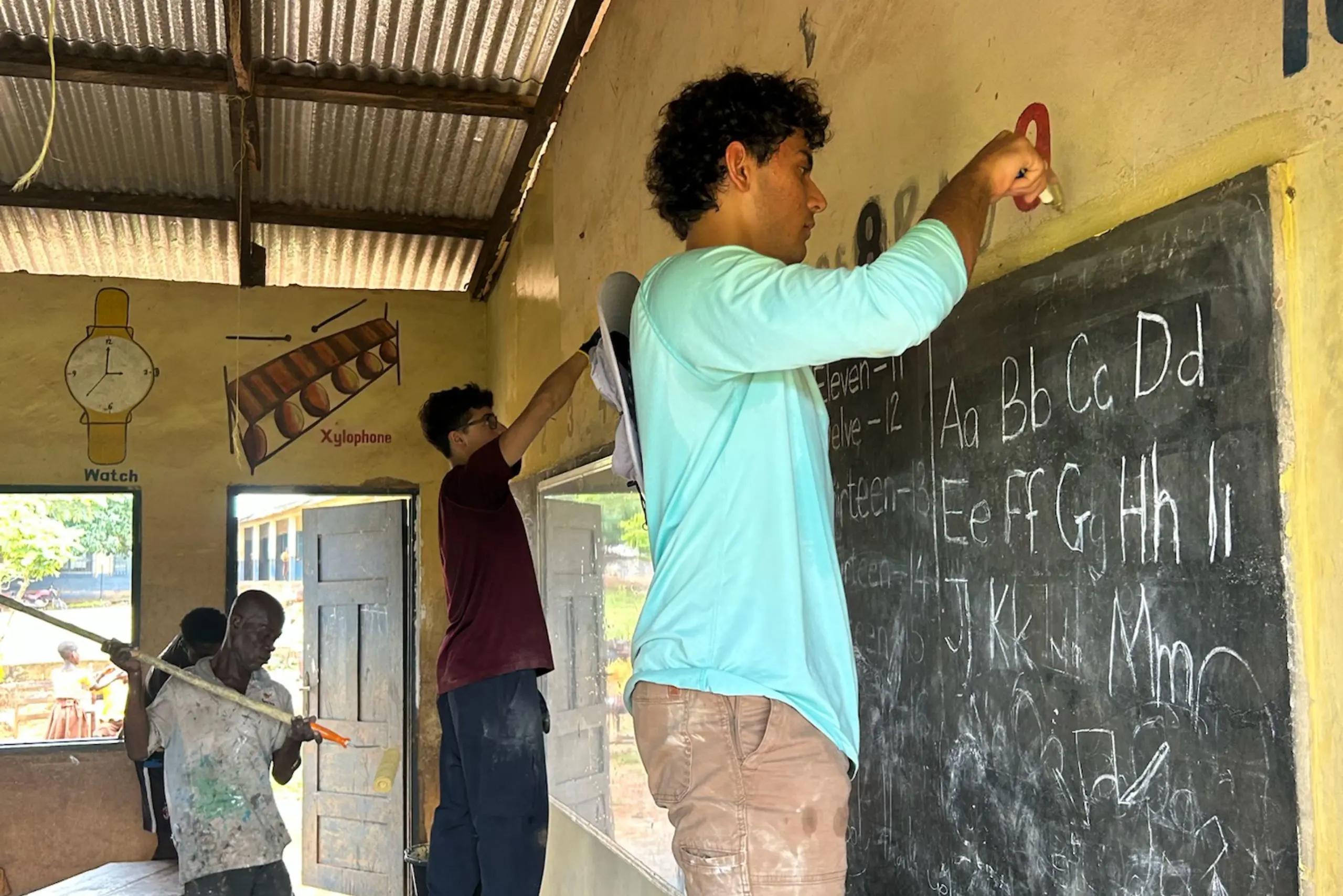 Student helping in Ghana