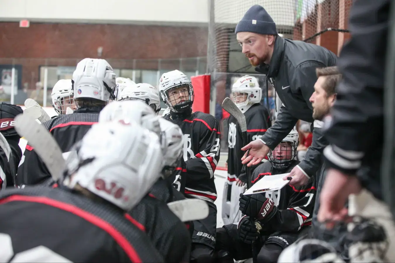 Hockey coach talking to team