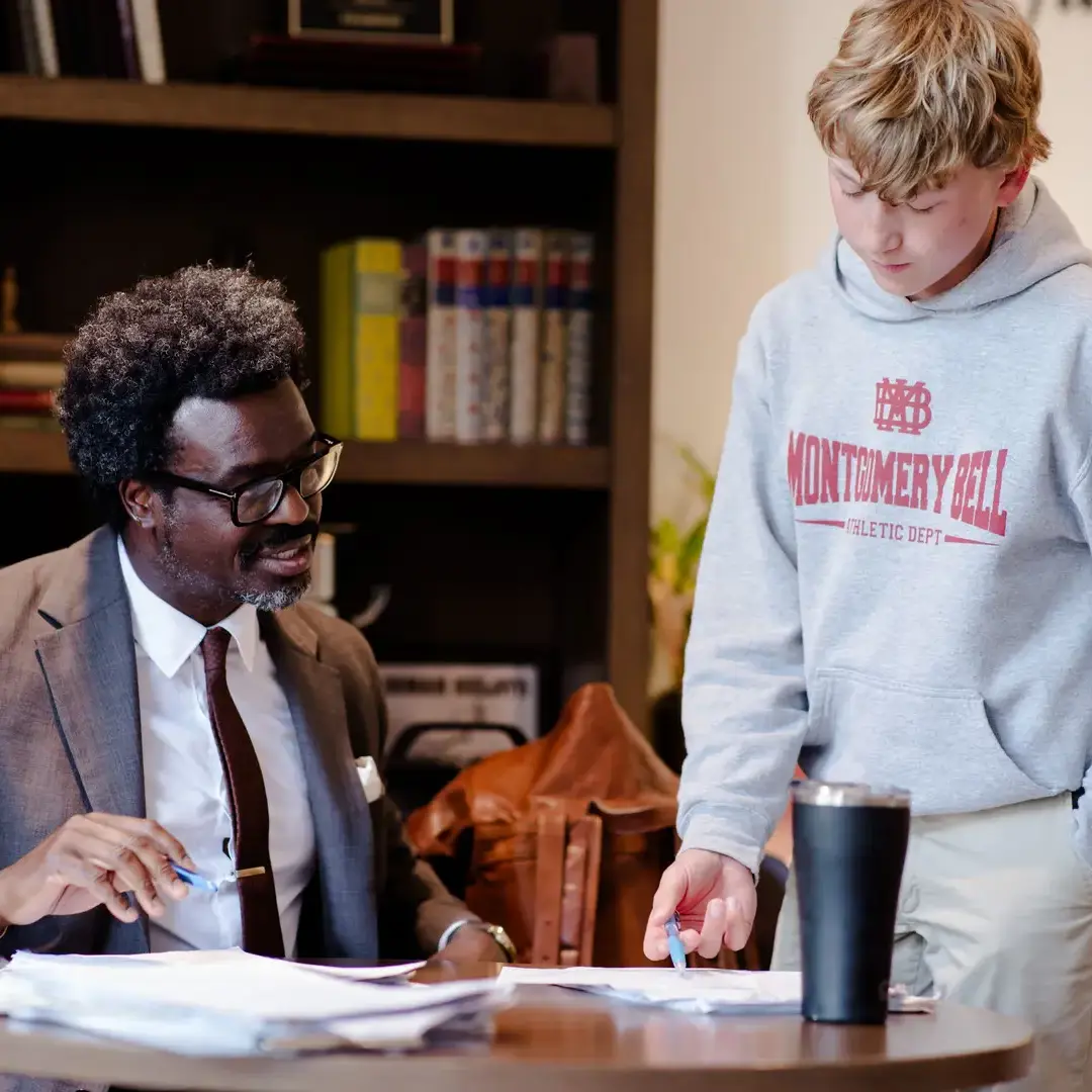 Teacher looking at students work