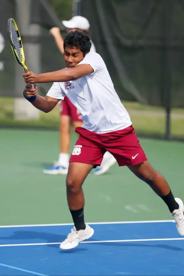 Tennis player mid-serve