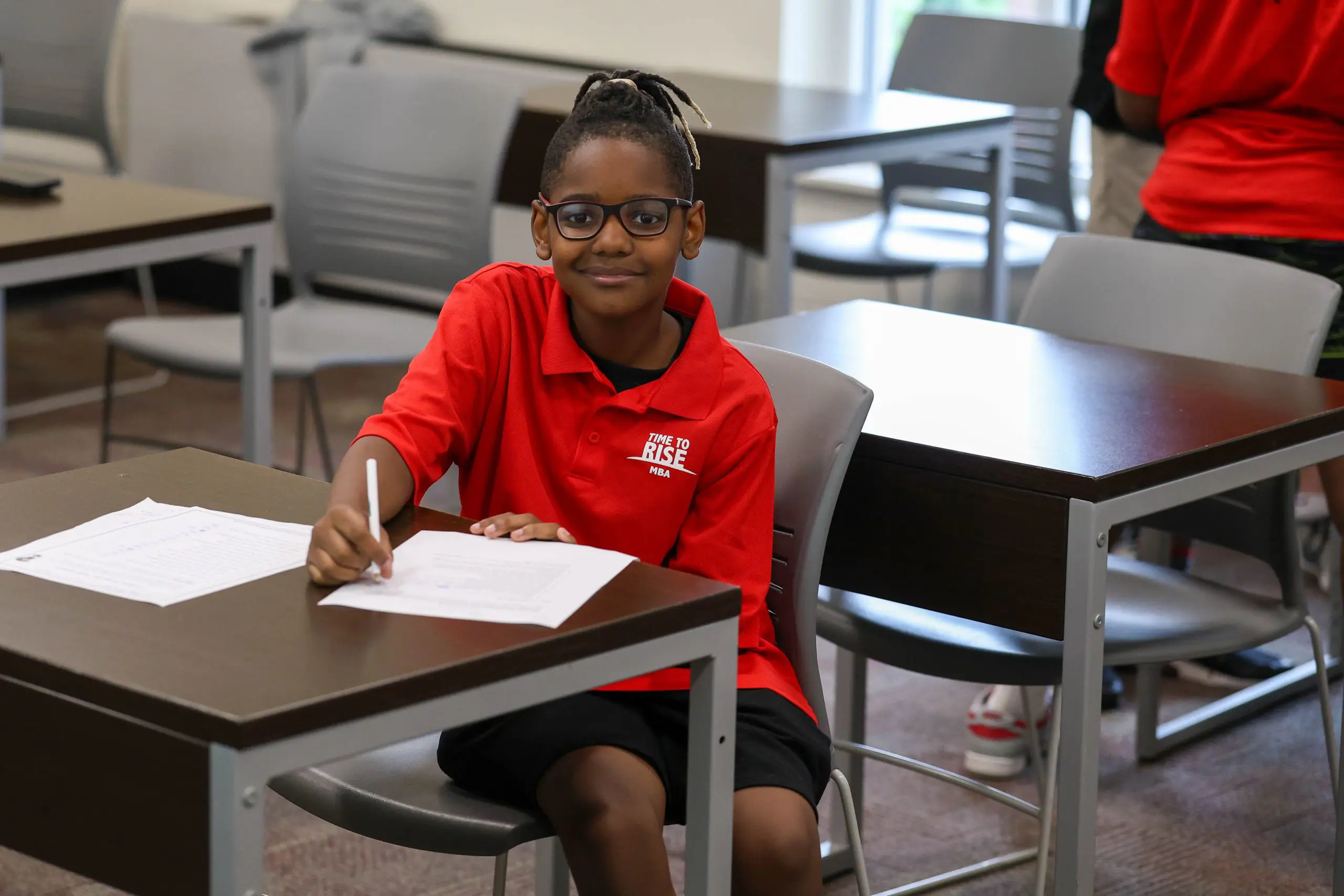 Student smiling and doing work